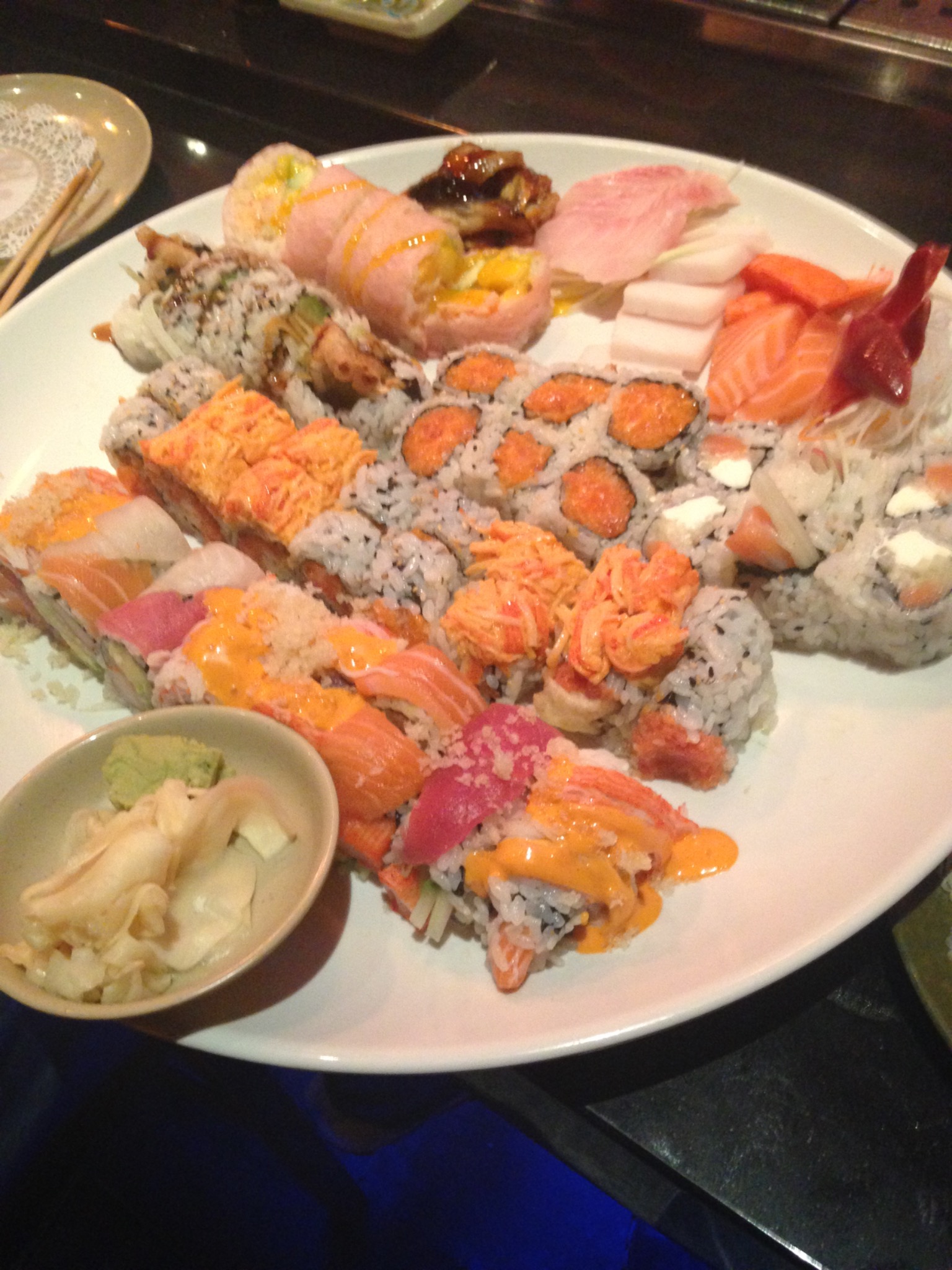Large sushi platter with assorted rolls and sashimi