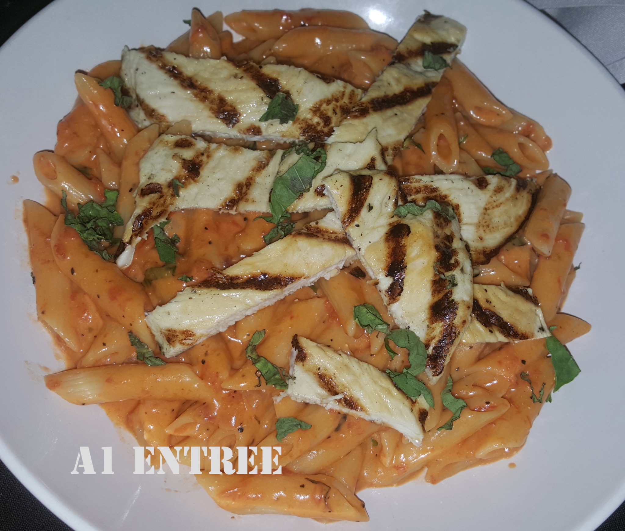 Close-up of penne vodka with grilled chicken