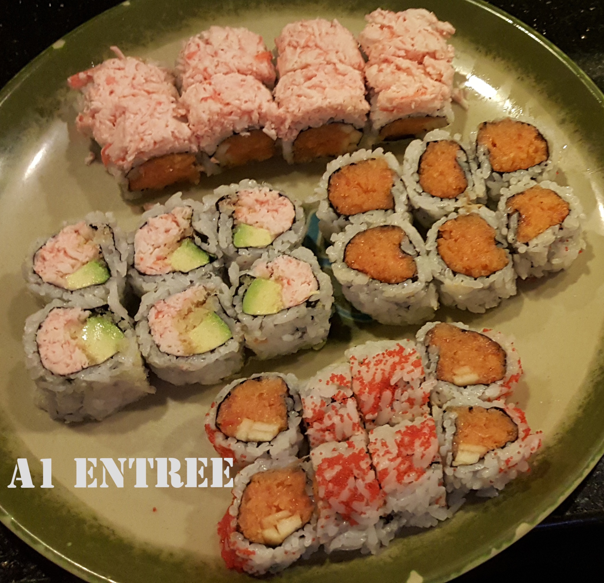 Sushi assortment with avocado and spicy rolls